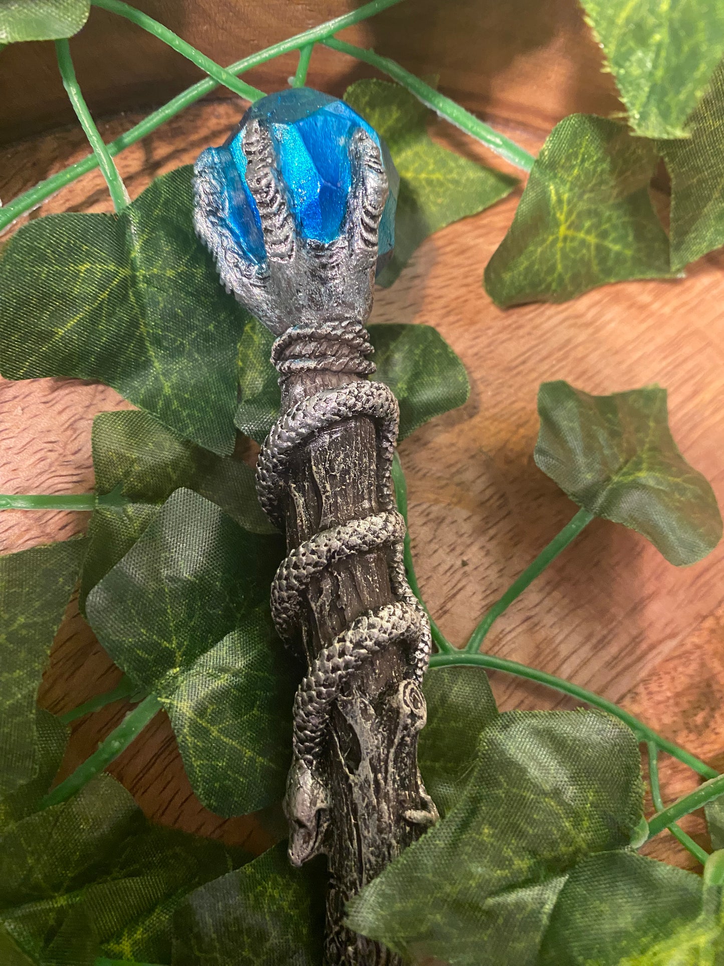 Silver claw with blue gem wand